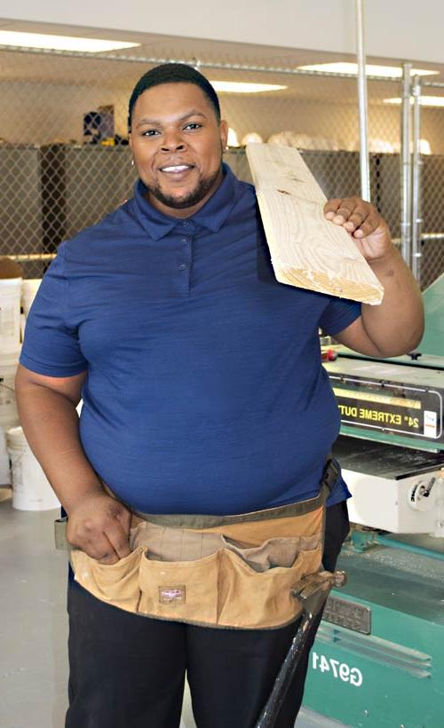 Student holding lumber